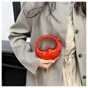 Detailed relief of moon face on red crescent moon bag with golden chain strap