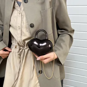 Glossy black heart-shaped chain handbag with mirror finish and gold metal strap