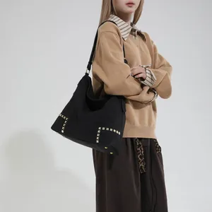 Large black shoulder tote bag with vintage gold rivets and matte suede texture