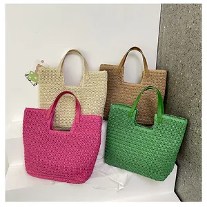 Macro detail of natural straw tote bags in four vibrant colors with leather handles