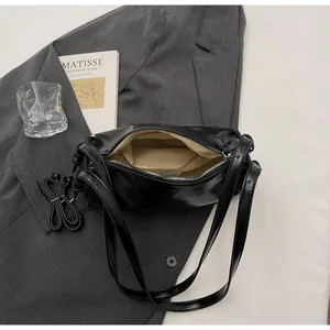 Black PU leather hobo bag featuring smooth texture, zipper closure and adjustable strap