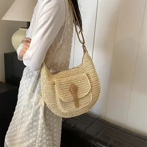 Straw beach shoulder bag with brown leather strap and decorative flap pocket