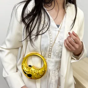 Golden crescent moon chain bag with mirrored metallic finish and celestial star texture