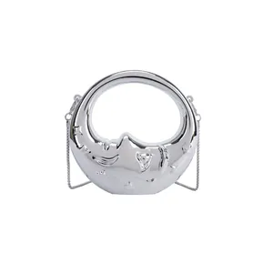 Silver crescent moon handbag with mirror finish, star relief and metal chain strap