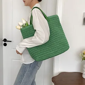 Spacious green woven tote bag for summer beach holidays featuring a minimalist design