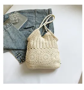Close-up of cream crochet tote bag with bohemian floral pattern and woven texture