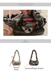 Detail view of camouflage pleated baguette bag with bow and spacious interior display