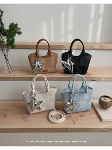Detail of vintage canvas bucket bags with star pendants in four stylish colors