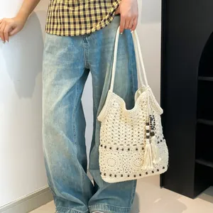 Bohemian crochet tote bag with geometric patterns, fringe tassels, and wooden beads