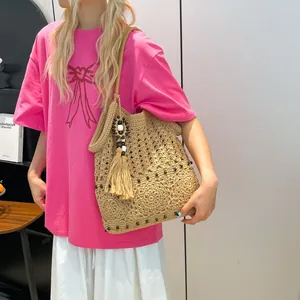 Handcrafted boho crochet tote bag with tassels and beads for beach vacations