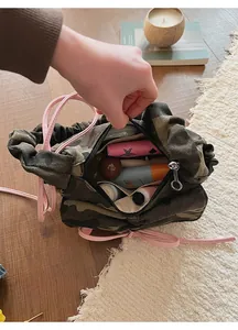 Interior view of camo baguette bag showing spacious storage for cosmetics and essentials