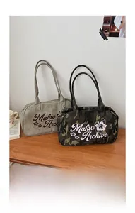 Detail of vintage canvas shoulder bags with flower prints and Mafav Archive lettering
