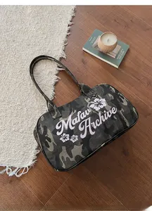 Top view of camouflage canvas tote bag with pink floral patterns and zipper detail