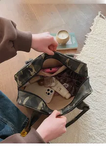 Interior view showing the large capacity and inner zipper pocket of the camouflage tote bag