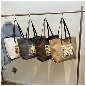Detail of four canvas tote bags in cream, grey, brown, and khaki with Egyptian illustrations