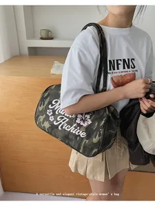 Macro view of camouflage shoulder bag with Archive text and floral print details