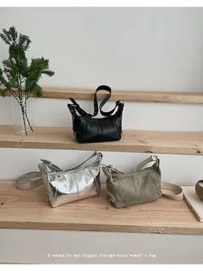 Detailed comparison of three vintage leather shoulder bags in black, silver, and olive green