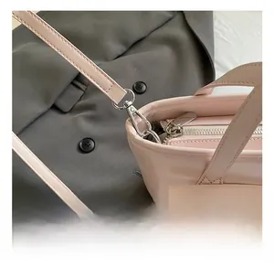 Close-up of the silver metal D-ring and swivel hook details on this pink tote bag