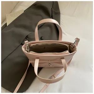 Pink leather tote bag interior view showing large compartment and metal zipper pocket
