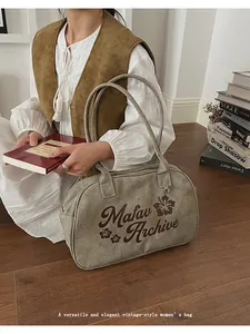 Vintage canvas tote bag with floral print and Mafau Archive lettering shown with model