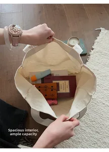Top view of spacious cream canvas tote interior showing large capacity for daily items