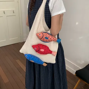 Minimalist cream knit tote bag featuring three colorful stuffed fish 3D charms for women