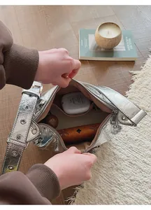 Interior detail of silver textured handbag showing spacious capacity for daily essentials