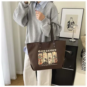 Close-up of brown canvas tote with Egyptian art and GORGEOUS typography in a stylish setting