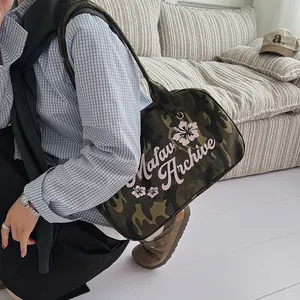 Camouflage shoulder bag with pink hibiscus flowers and Matav Archive lettering print