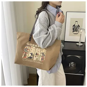 Detailed shot of khaki canvas tote with Anubis print and dark brown leather straps