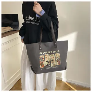 Detail view of Anubis tote bag showing canvas texture and yellow graphic print