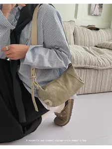 Detail of vintage canvas shoulder bag with textured fabric and adjustable leather strap