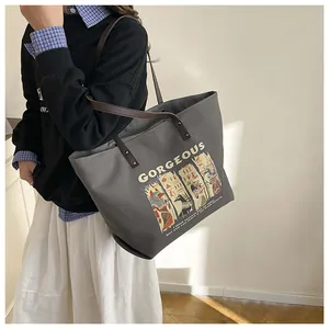 Deep grey canvas tote bag with brown leather handles and Egyptian style illustration