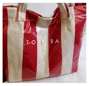 Detail showing waterproof striped fabric and Tote Bag text on a glossy surface
