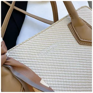 Détail de la texture en toile tissée et poignées en cuir avec foulard sur un sac à main