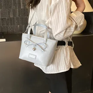 Fashion light blue tote bag with ribbon bow and silver heart pendant for women