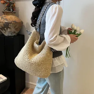 Large straw woven tote bag with monochrome pattern strap and bow for summer beach vacation