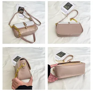 Detail view of pink and white color-block crossbody bag with metal chain and leather strap