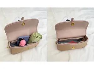 Detail view of pink and brown crossbody bag interior showing main pocket capacity