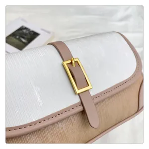 Detail of contrast color flap bag featuring vertical striped texture and golden buckle