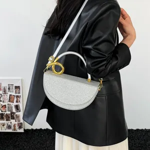 Chic silver sequin handbag with a large gold metal ring handle for evening fashion