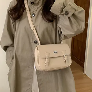 Chic beige lychee grain leather messenger bag with silver twist lock and adjustable strap