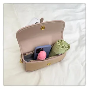 Interior view showing spacious compartments and storage of phone and umbrella in crossbody bag