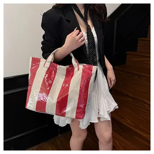Detail of large waterproof tote bag featuring red and white stripes and PVC coating