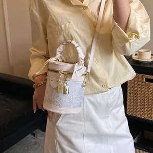 Elegant bucket bag in cream with lace embroidery and silk scarf handle for women