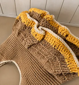 Macro detail of the scalloped ruffle edge on a tri-color contrast knit tote bag