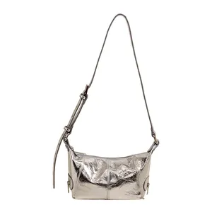 Silver metallic crinkled leather crescent shoulder bag with adjustable strap and side zips