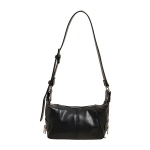 Minimalist black crescent hobo bag with textured leather and silver hardware details