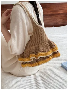 Brown crochet tote bag with yellow ruffled edge shown in a cozy home setting