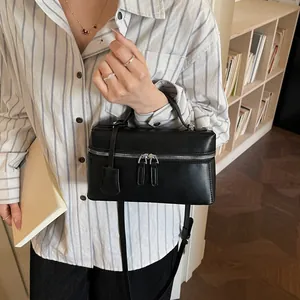 Minimalist black leather vanity case handbag with silver hardware and top handle